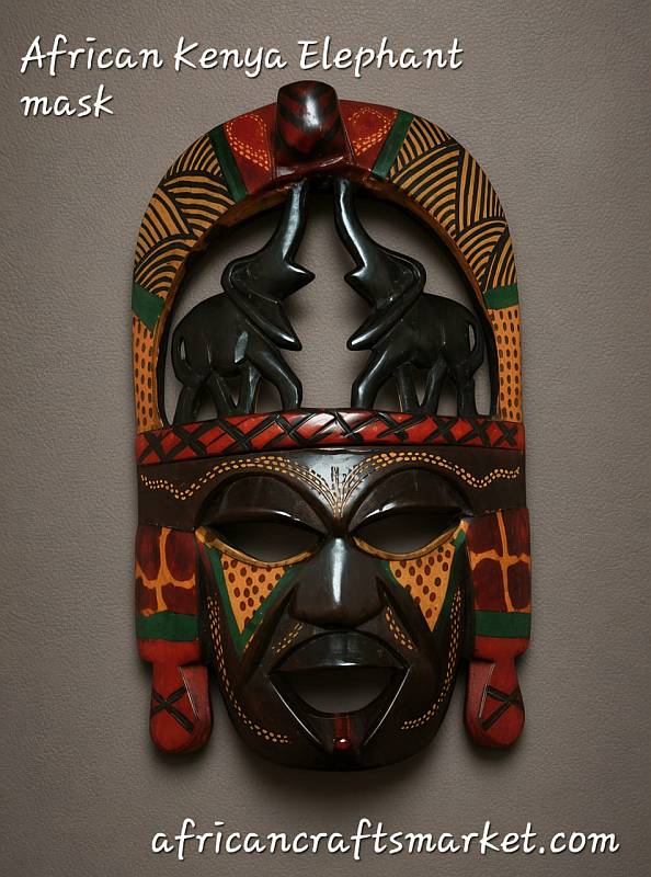 and carved Maasai wooden mask with elephant designs
