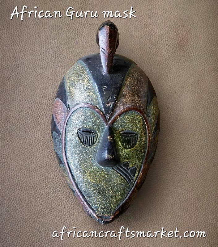 A handcrafted African Guro wood mask from Ivory Coast featuring intricate carved details, an elegant elongated face, and hand-painted finish
