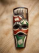 Hand-carved wooden Swazi mask featuring red and green geometric hand-painted patterns