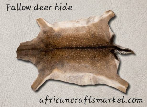 Premium tanned African Fallow Deer skin hide flat lay showing the rich chestnut coat covered in distinct white spots and a dark spine stripe