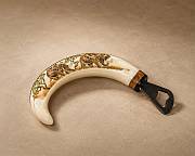 A premium selection of handcrafted African warthog tusk bottle openers showcasing the natural variation in ivory curves and polished brass caps