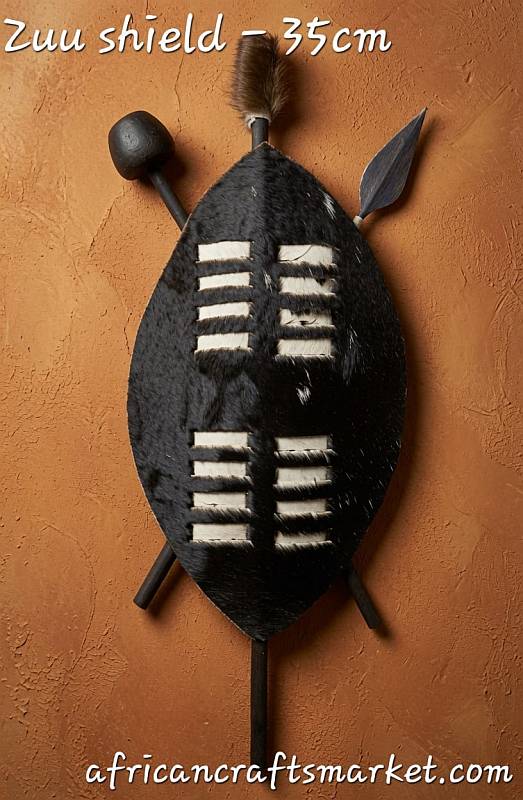 Small 35cm Zulu shield made from dark patterned Nguni cowhide, traditional African art piece sourced near Durban.