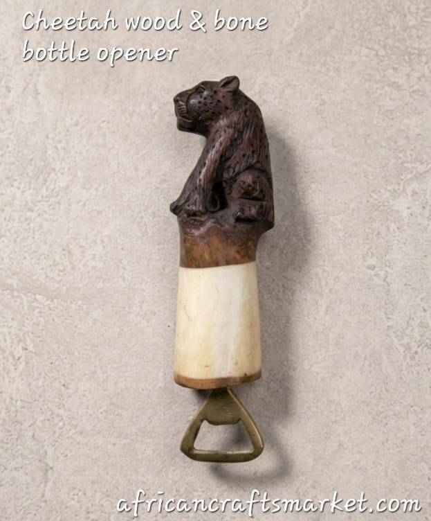 A luxury handcrafted African bottle opener featuring a beautifully carved wooden body and polished animal bone accents seamlessly joined to form a sleek cheetah silhouette, complete with hand-painted spots