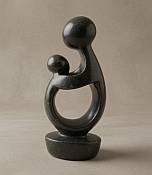 Genuine handcrafted African stone mother and infant statue, showcasing a polished, tactile finish and natural mineral grain