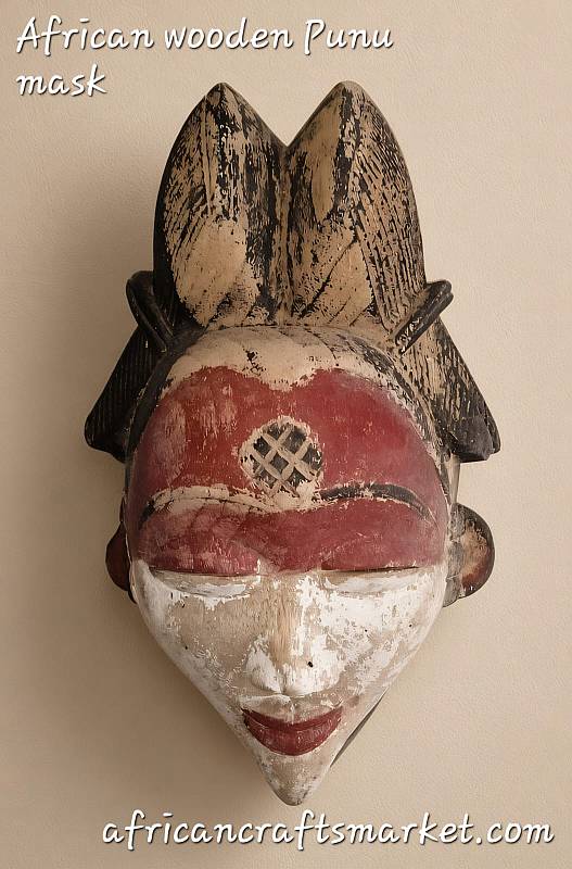Authentic African Punu Mukudj wooden mask featuring intricate raised scarification patterns