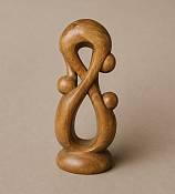 Front view of a genuine handcrafted wooden three-head family statue showcasing beautiful contrasting grain of the  light wood tones.