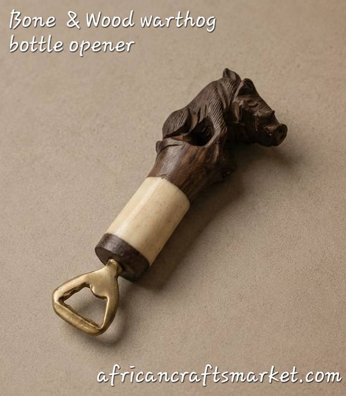 An authentic, handcrafted bottle opener featuring a detailed warthog head carved from rich wood and genuine bone